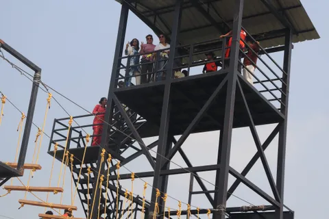 Students on the zipline launch platform at the Marvel Adventures activity park